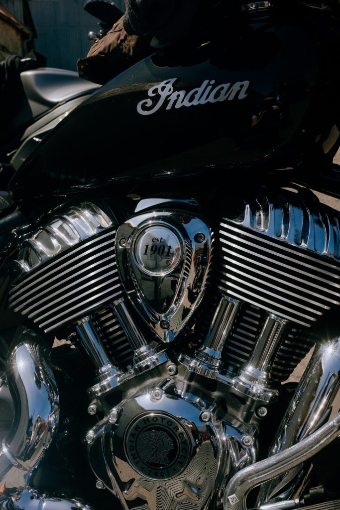 Close-up of a black Indian motorcycle engine with chrome details and the "Indian" logo.